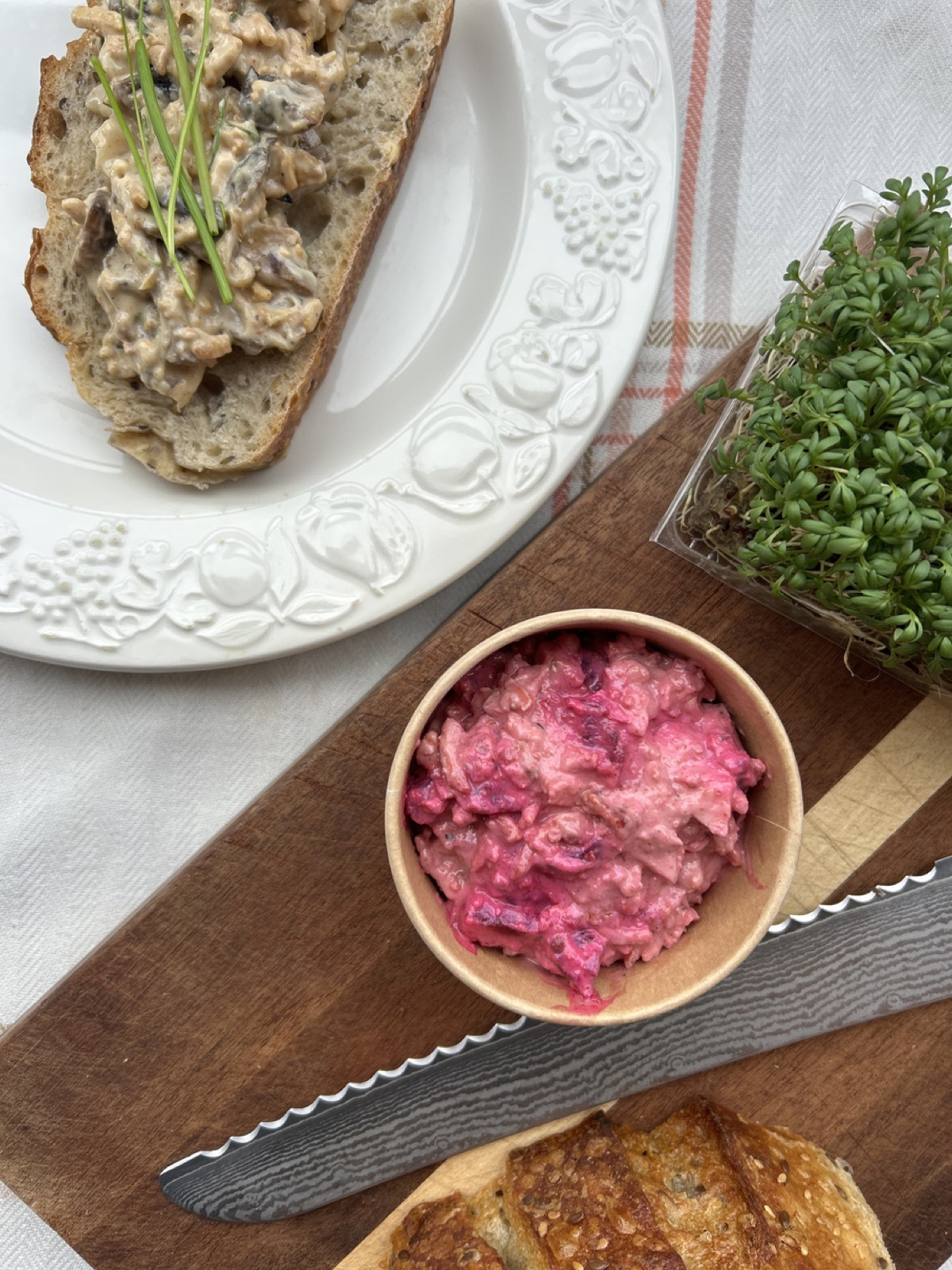 A deep-pink beet salad flecked with apple cubes, horseradish cream, and Sloppy Jo's Basic Filling, plated on a board